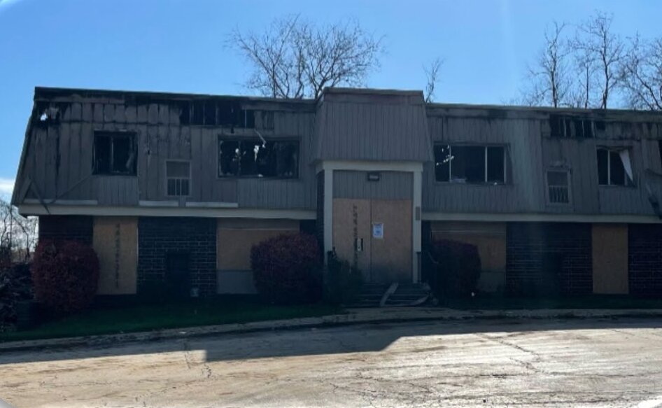 Cambridge Square, Monroeville, PA — before: a fire-damaged, boarded-up apartment building